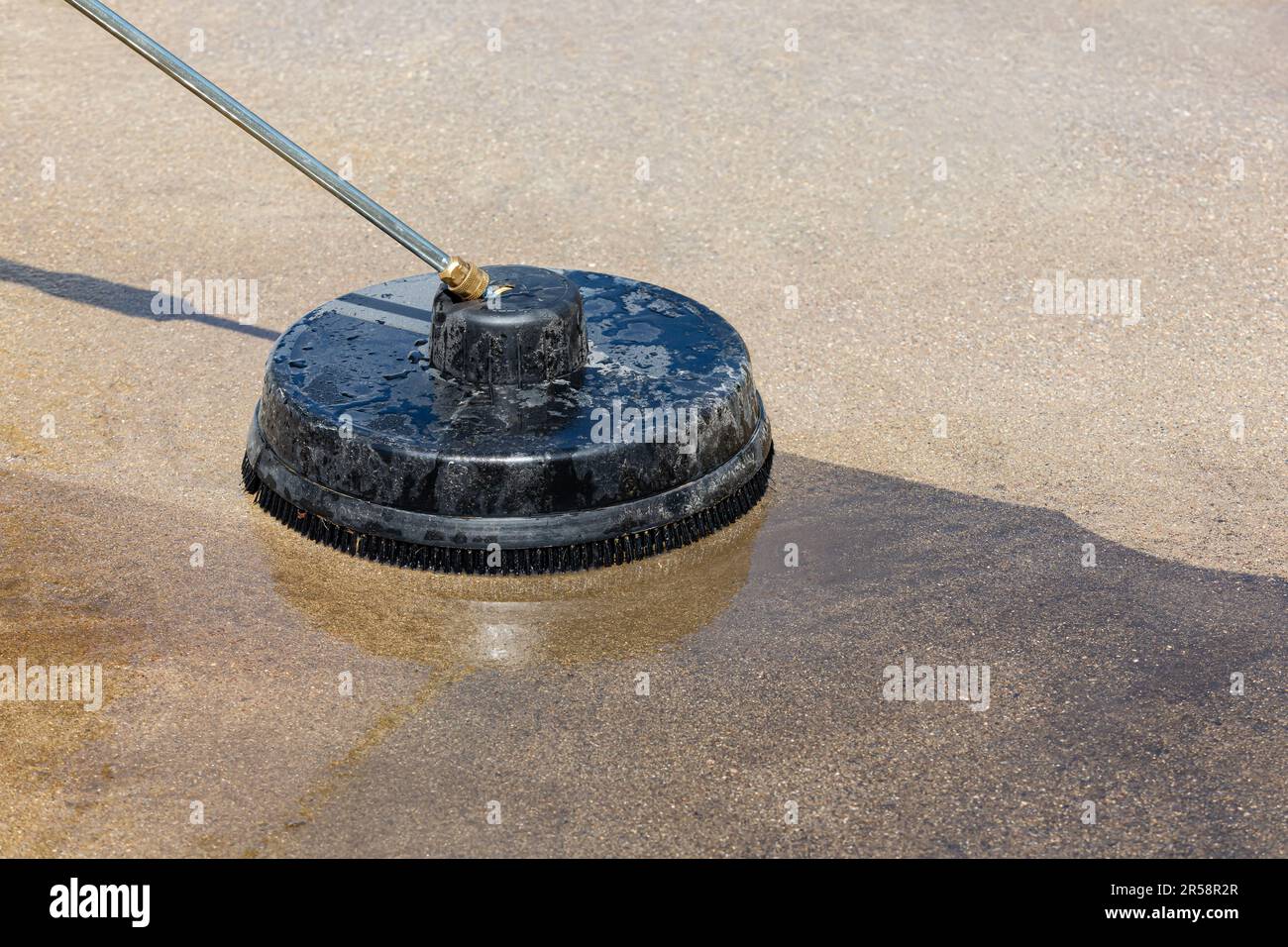 Pressure washing and cleaning dirty concrete driveway. Home cleaning, maintenance and household chores concept Stock Photo