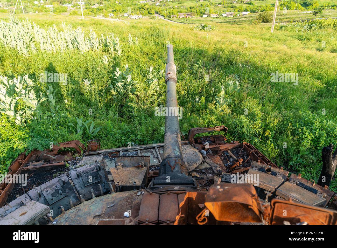 View of destruction of village of Bohorodychne in Donetsk region by Russian forces during occupation from August 2022 until September 2022 from destroyed Russian tank used to shell the village. Russian forces attacked the village in May 2022 and finally occupied the village in August for 2 months, it was liberated in September 2022. From the hills surrounding the village Russian forces shelled and destroyed homes, school and the famous Church of the Holy Mother of God ‘Joy of All Who Sorrow'. The church became a convent of the Sviatohirsk Lavra in 2008. The church belongs to the Ukrainian Orth Stock Photo