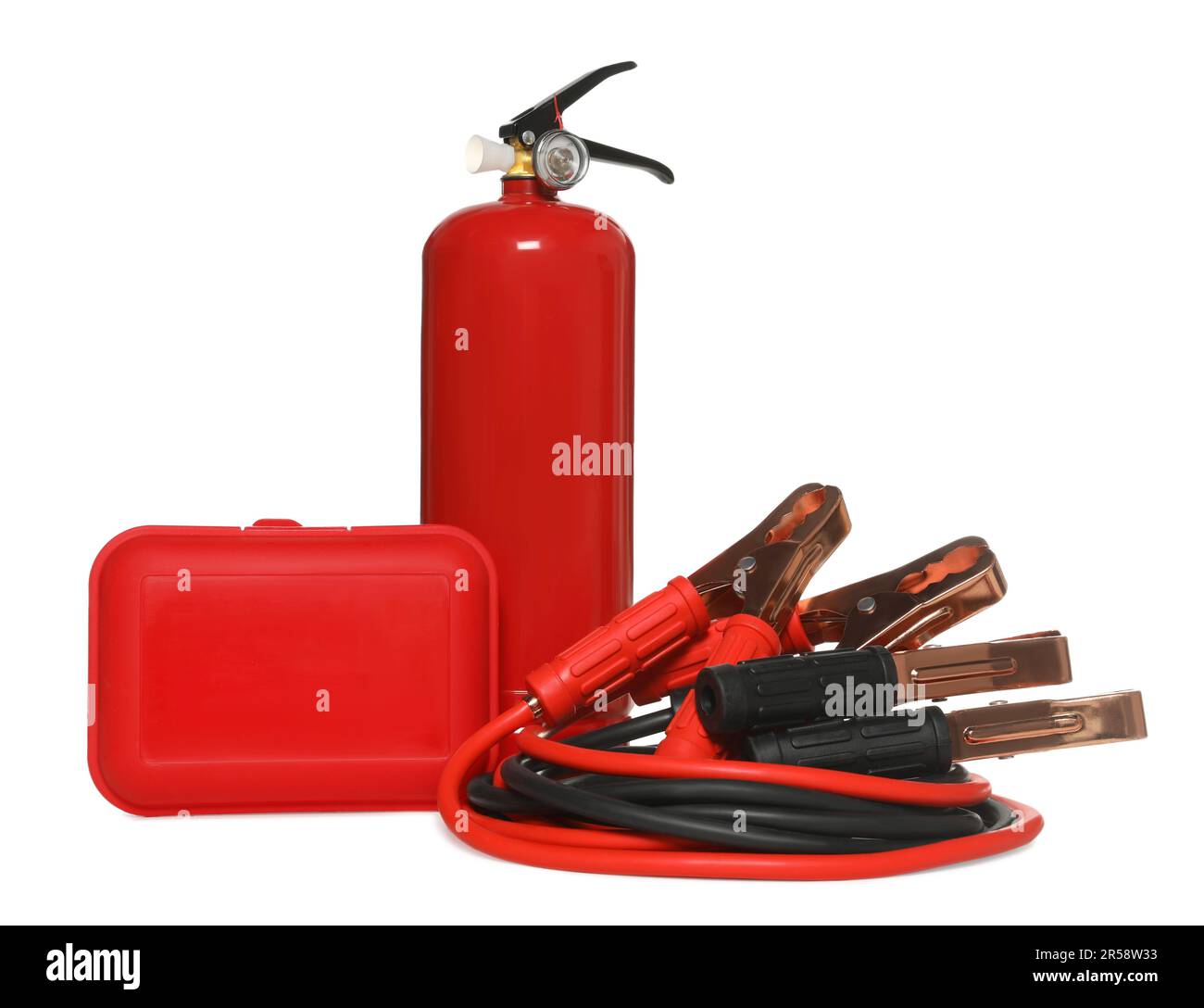 Red fire extinguisher, first aid kit and battery jumper cables on white