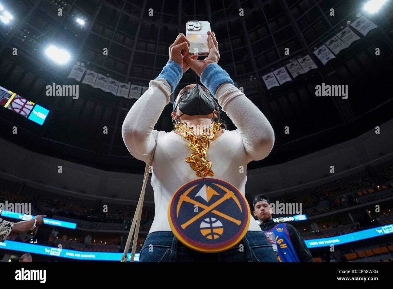 A Denver Nuggets fan takes a photo before Game 1 of the basketball team