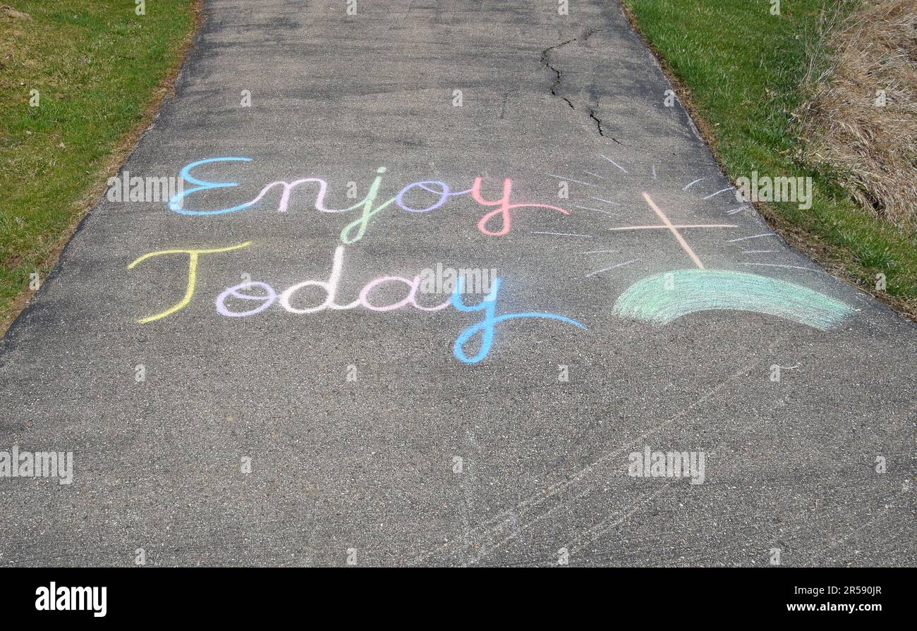 Uplifting chalk art message 'Enjoy Today' Stock Photo