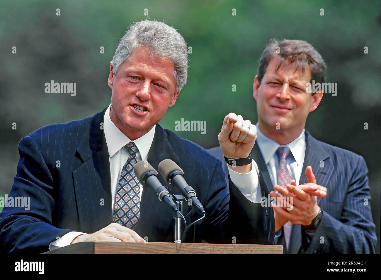 WASHINGTON DC - AUGUST 10, 1993 President William Jefferson Clinton and Vice President Albert Gore Jr. address the crowd gathered on the South Lawn of the White House to witness the signing of the Budget deficit bill signing. Clinton signed the Omnibus Budget Reconciliation Act of 1993 which passed Congress without a single Republican vote. It raised taxes on the wealthiest 1.2% of taxpayers, while cutting taxes on 15 million low-income families Stock Photo