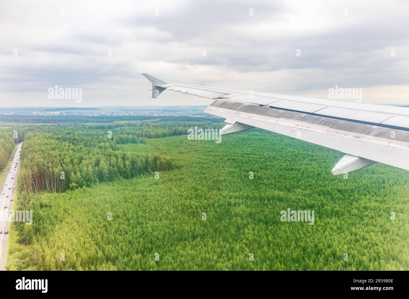 view-of-airplane-wing-blue-skies-and-green-land-during-landing