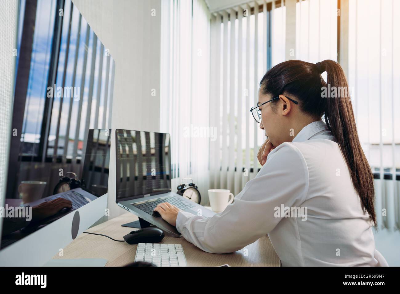 Asian female software developers are stressed in analyzing code-based systems. Stock Photo