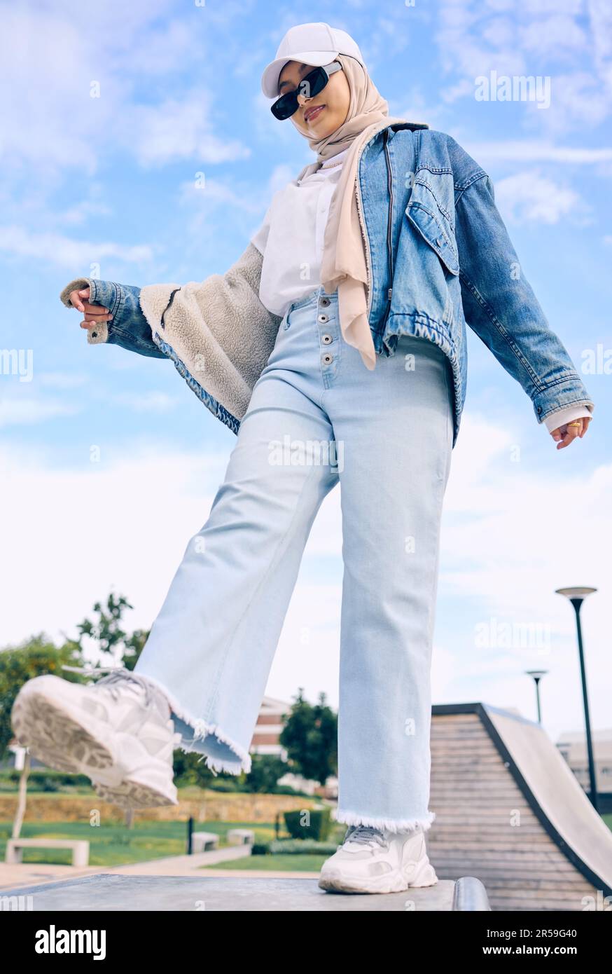 Balance, fashion or religion with a muslim woman outdoor in a cap and scarf  for contemporary style. Islam, faith and hijab with a trendy young arab  Stock Photo - Alamy