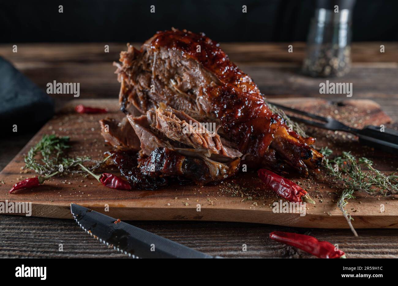Grilled turkey leg on wooden board. Delicious barbecue meat Stock Photo