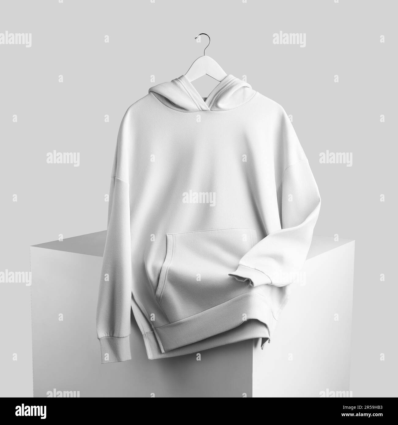 Mockup of a white hoodie on a hanger, cloudy on a cube, stylish clothes for design, product photography. Texture apparel, isolated on background, fron Stock Photo