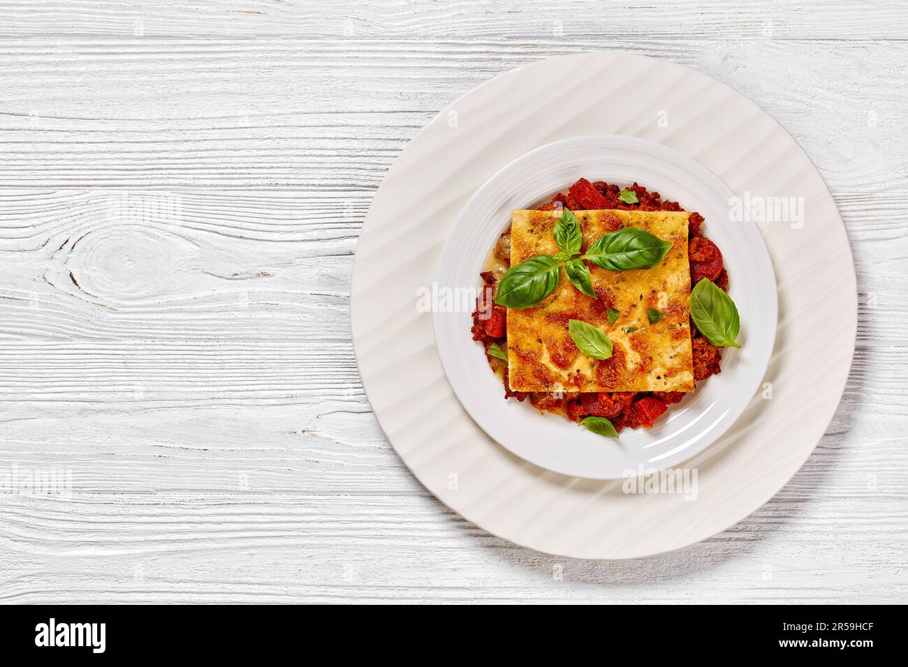 portion of upside down pizza of chorizo sausages, tomato sauce