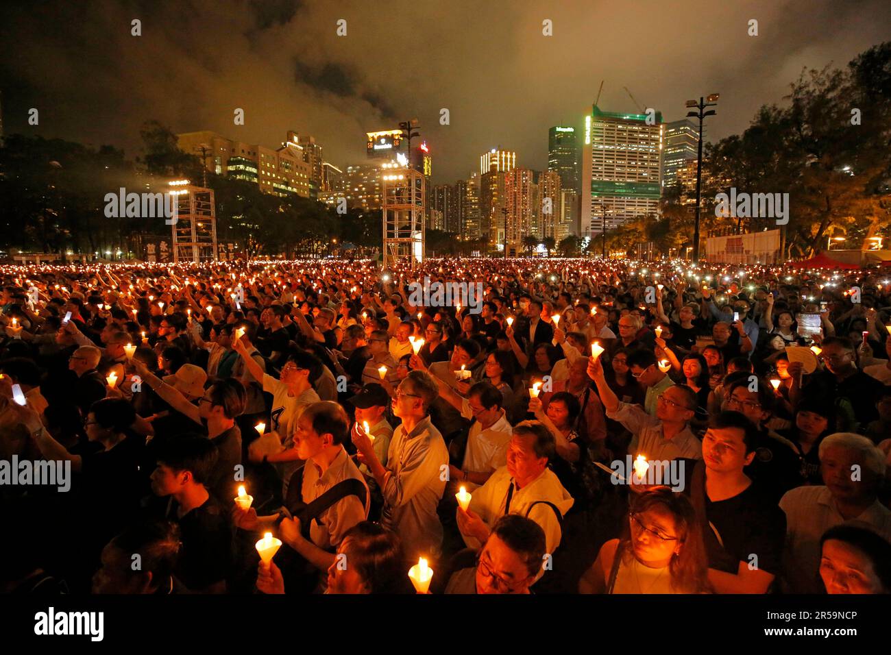 FILE - Thousands of people attend a candlelight vigil for victims of ...