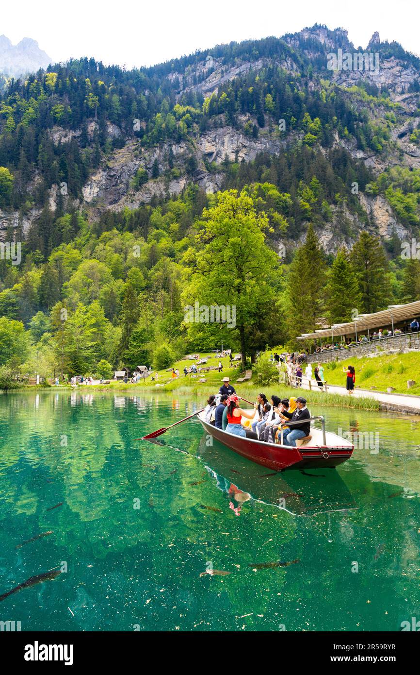 Tourists taking a boat ride on Blausee Lake (Blue Lake), Switzerland Stock Photo