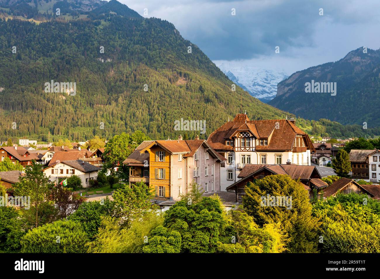 View of traditional style Swiss houses and mountains in Matten bei