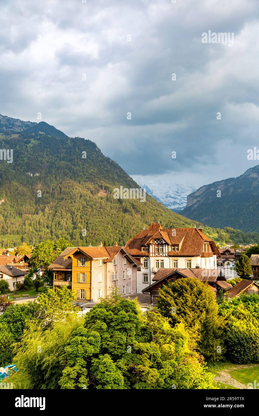 View of traditional style Swiss houses and mountains in Matten bei