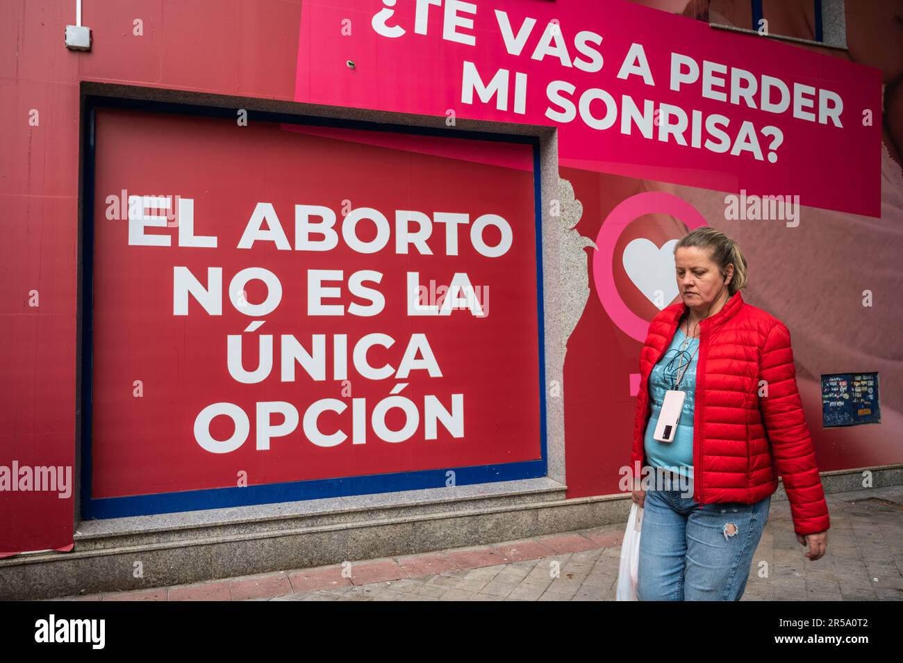 Madrid, Spain. 02nd June, 2023. A woman walks past a sign reading 'Abortion is not the only option' on the facade of the 'Pro Life Shelter' in front of the Dator clinic. The Dator clinic is one of the accredited clinics in Spain for the voluntary termination of pregnancy. Credit: Marcos del Mazo/Alamy Live News Stock Photo
