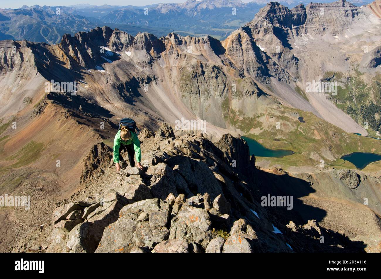 A woman climbs the Southwest ridge of Mount Sneffels (14,150 feet) in Southwestern Colorado. Stock Photo