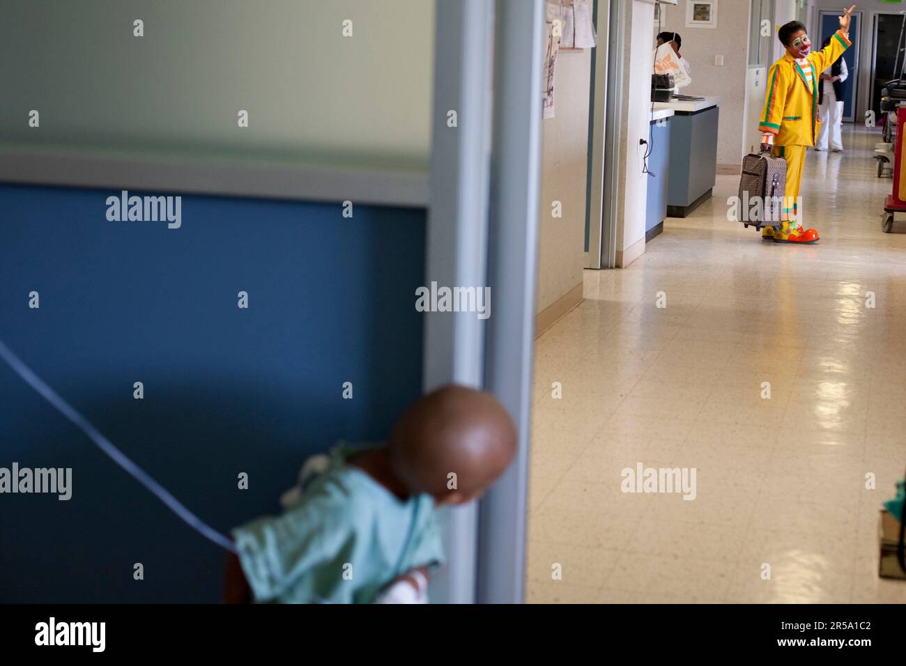 An evangelical Christian clown says goodbye to a child with leukemia at a hospital in Oaxaca, Mexico. Stock Photo