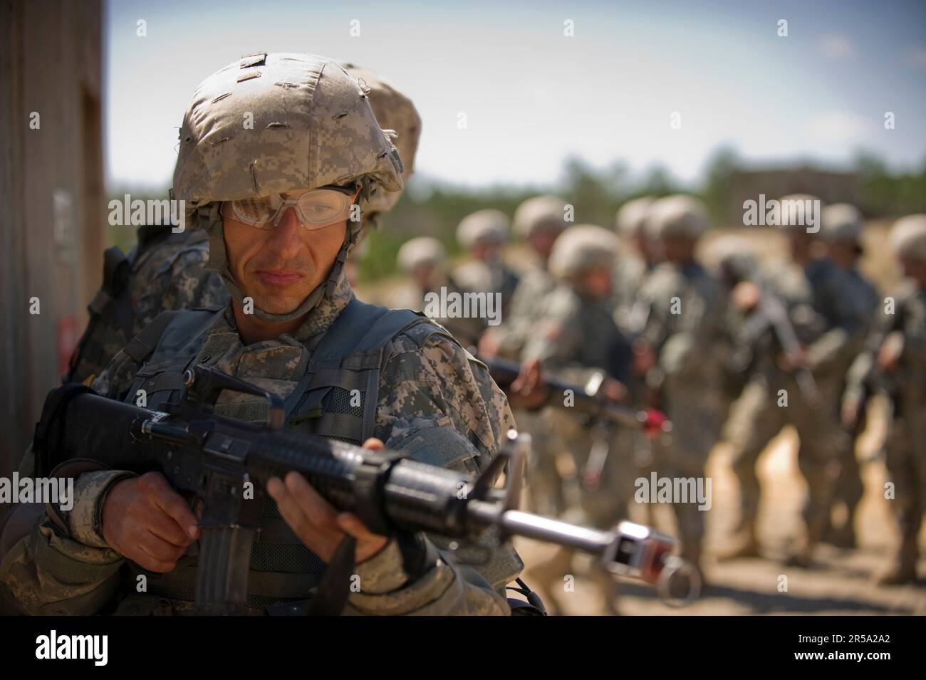 A soldier basic training provides rear security during close quarters combat training. Stock Photo