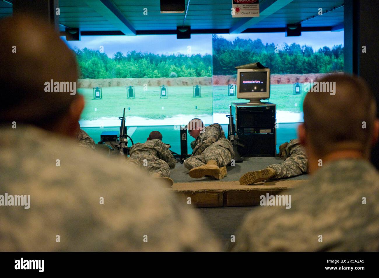 Soldiers conduct target practice at the indoor range during their preliminary weapons training course. Stock Photo