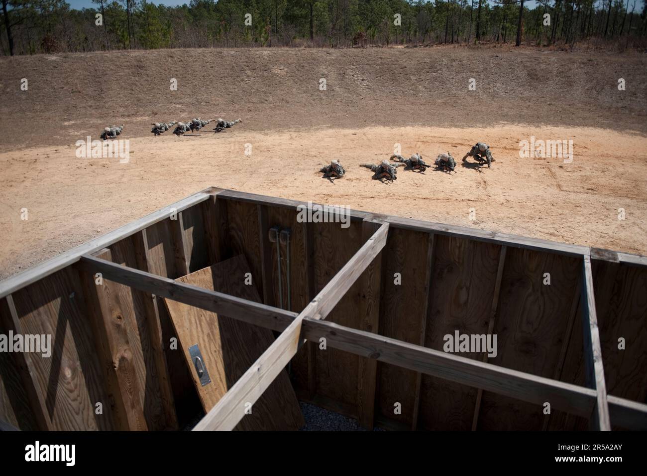Soldiers in basic training move tactically as a squad during close quarters combat training. Stock Photo