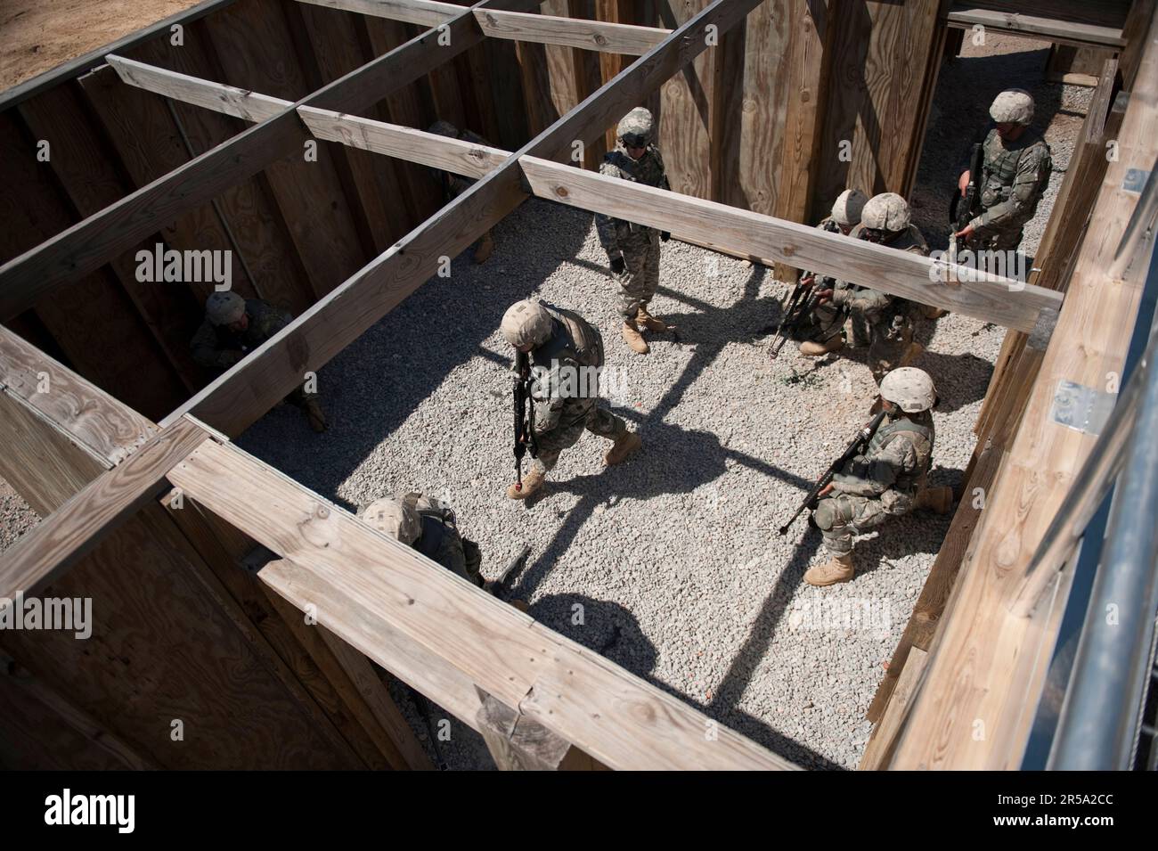 Soldiers in basic training move tactically as a squad during close quarters combat training. Stock Photo