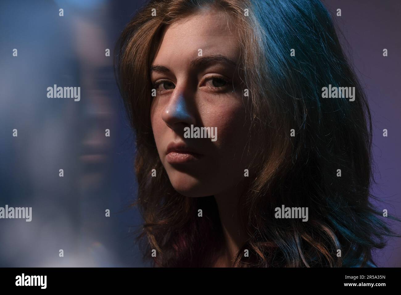 Portrait of sad teen girl looking at camera. Stock Photo