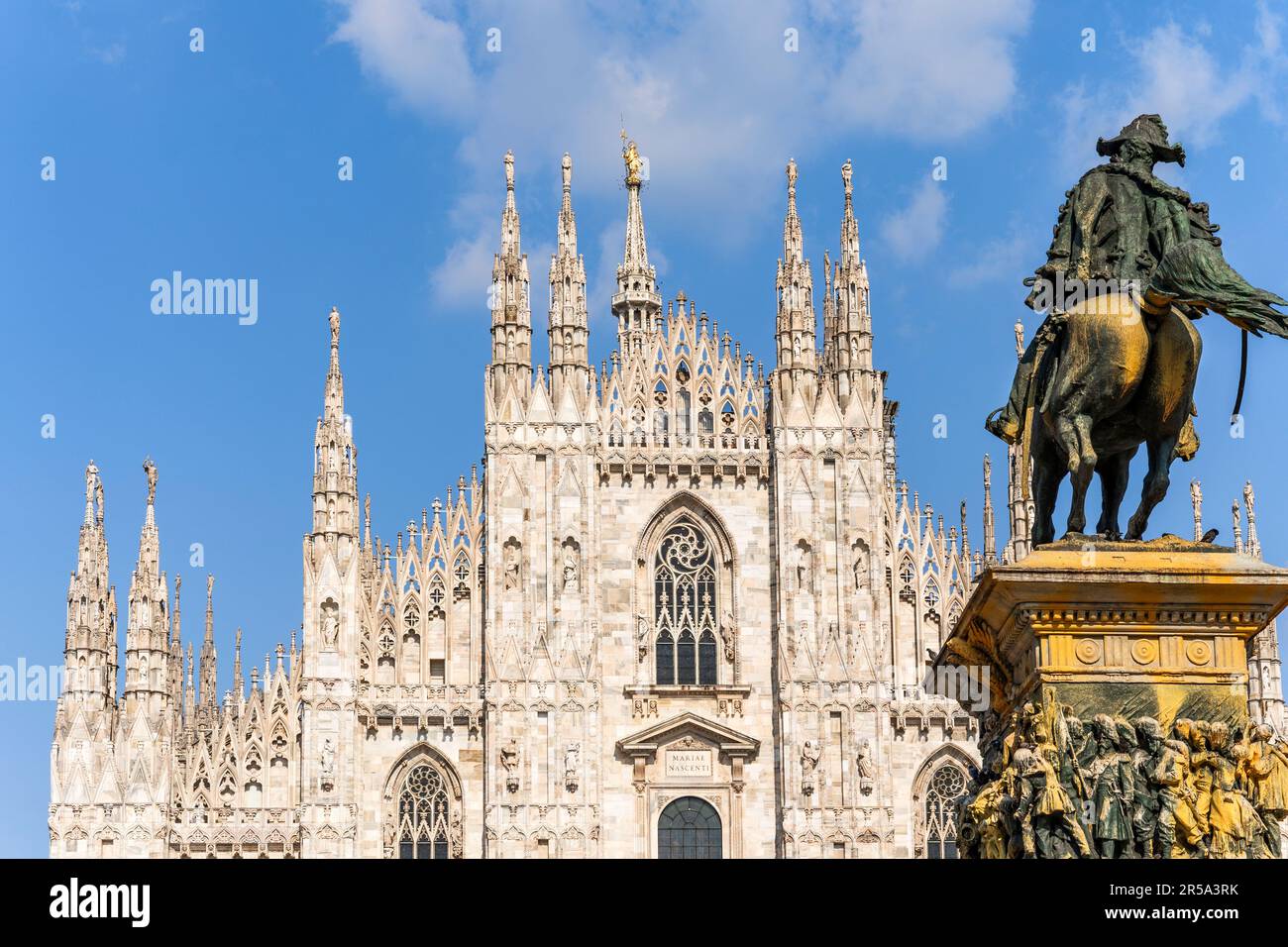 Façade of Milano Cathedral, landmark of the city, and the statue of Vittorio Emanuele II painted with yellow paint by environmental  activists, Italy Stock Photo