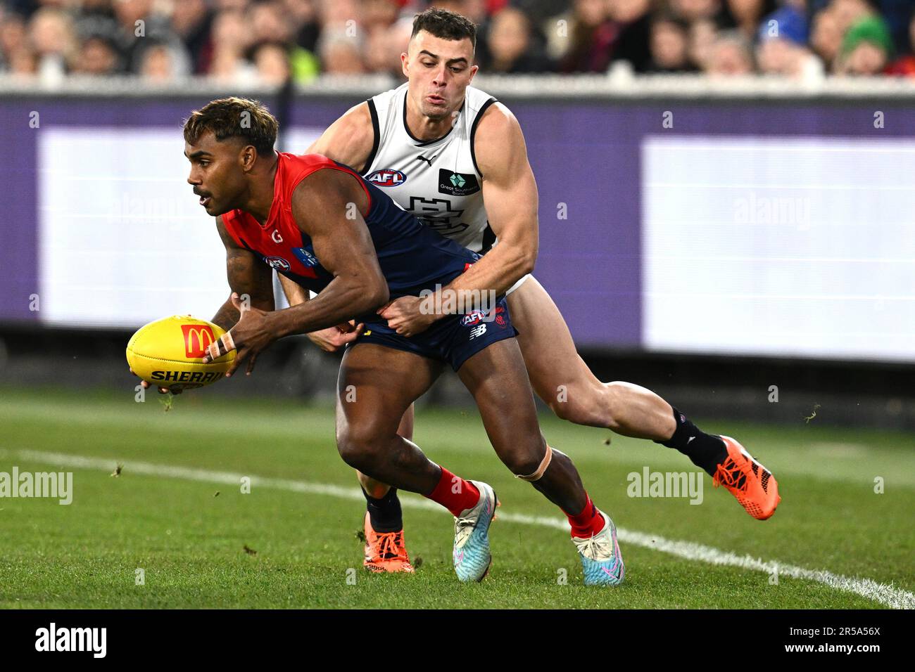 Melbourne, Australia. 02nd June, 2023. Alex Cincotta of Carlton tackles  Kysaiah Pickett of Melbourne during the AFL Round 12 match between the  Melbourne Demons and the Carlton Blues at the Melbourne Cricket