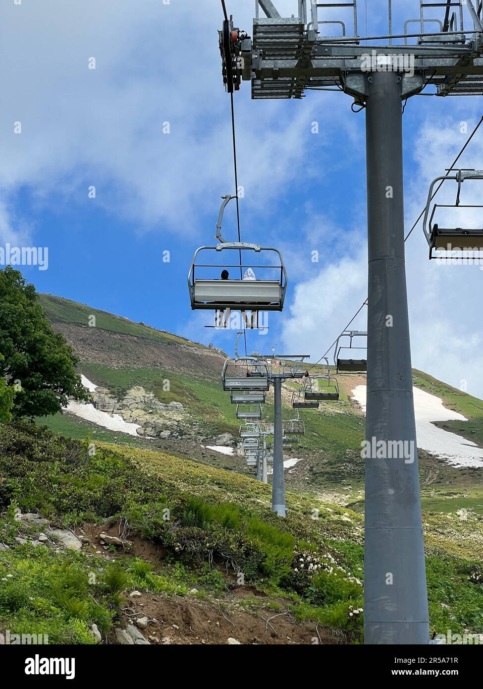 cable car in the mountains against the blue sky. Stock Photo