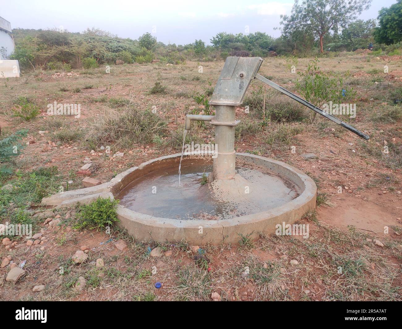 Water coming out from Deepwell Hand Pump Bore, Bore well Stock Photo