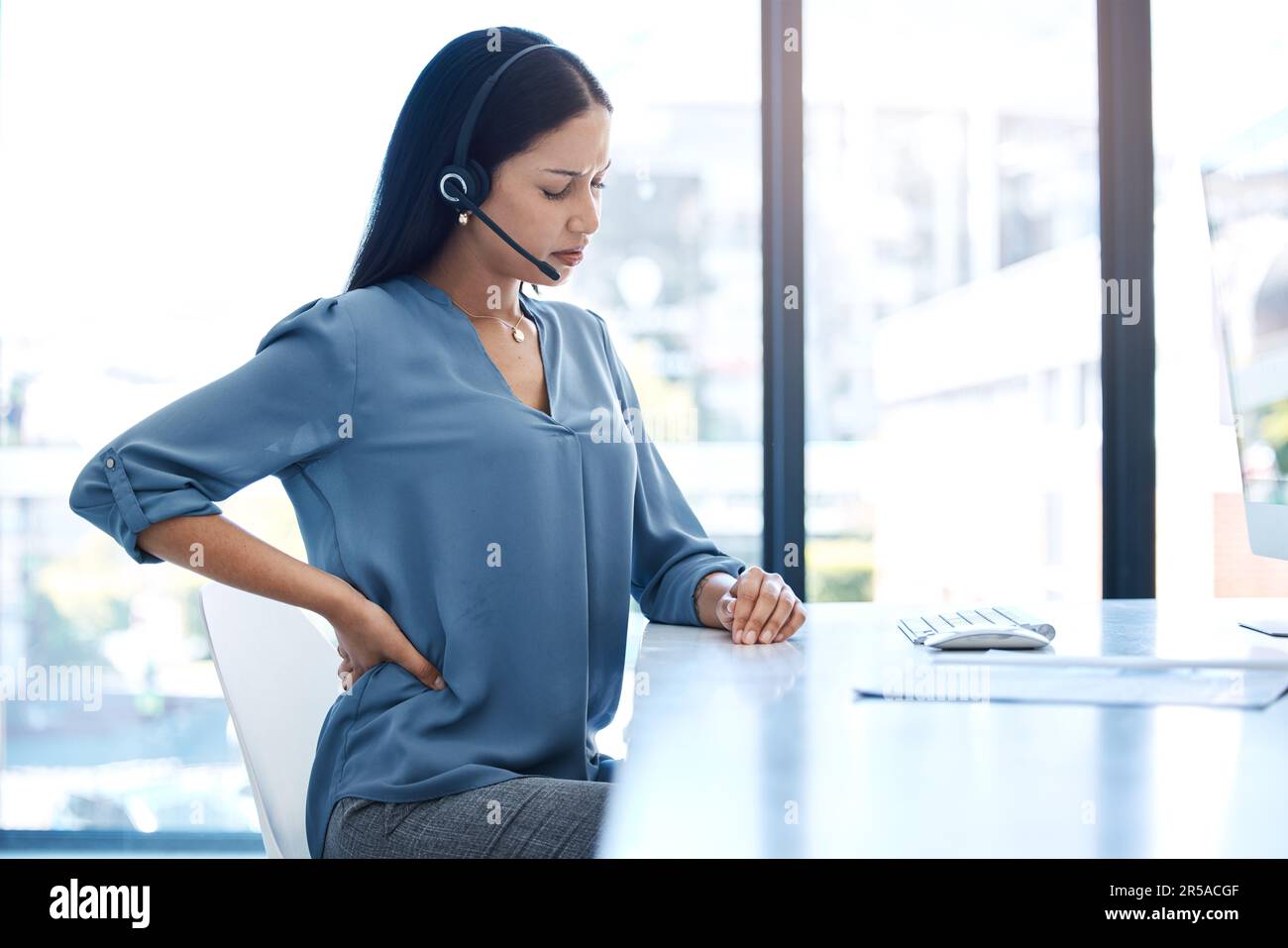 Back pain, stress and woman at a call center with posture issue while ...