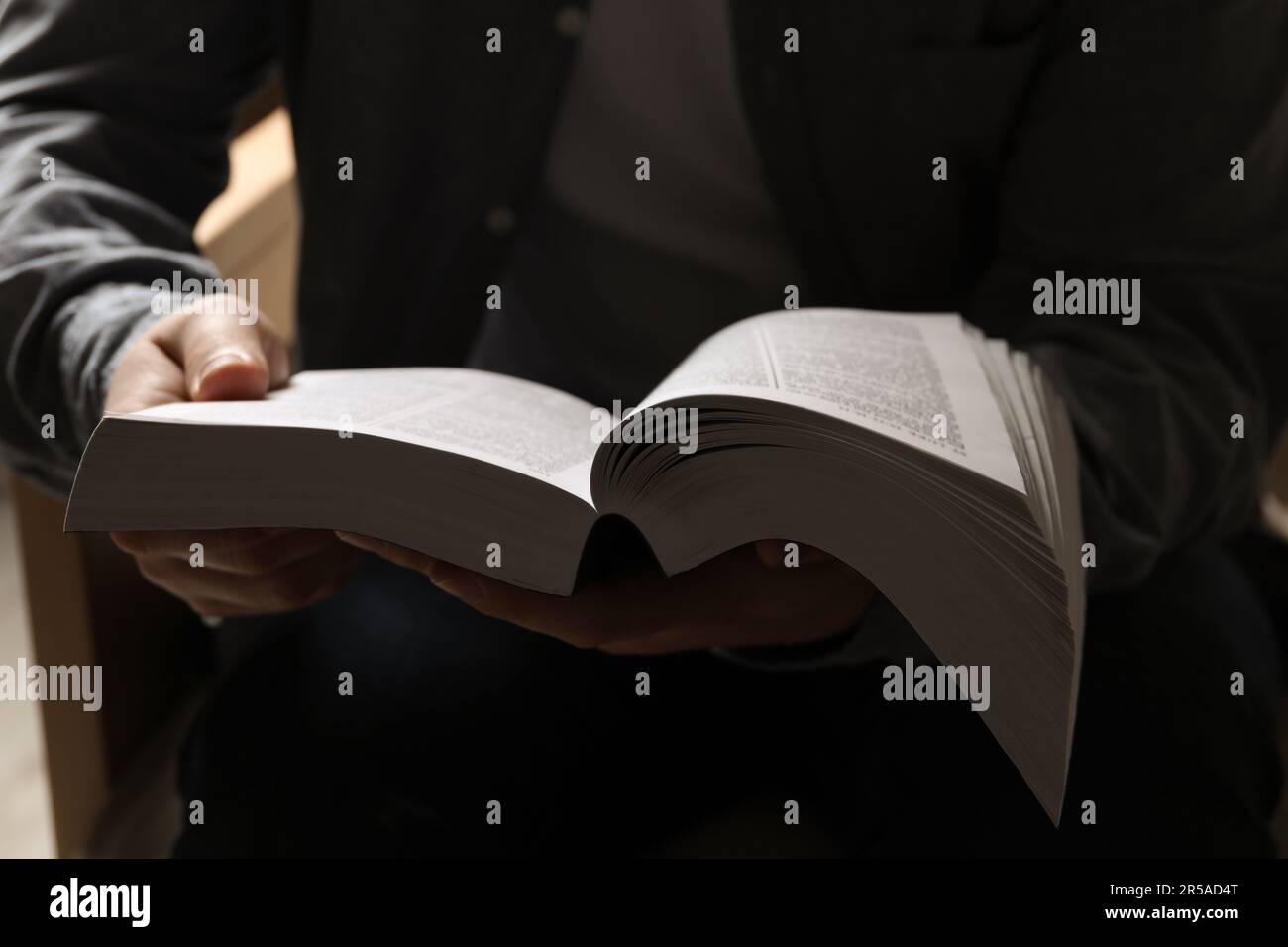 Man sitting and reading holy Bible, closeup Stock Photo