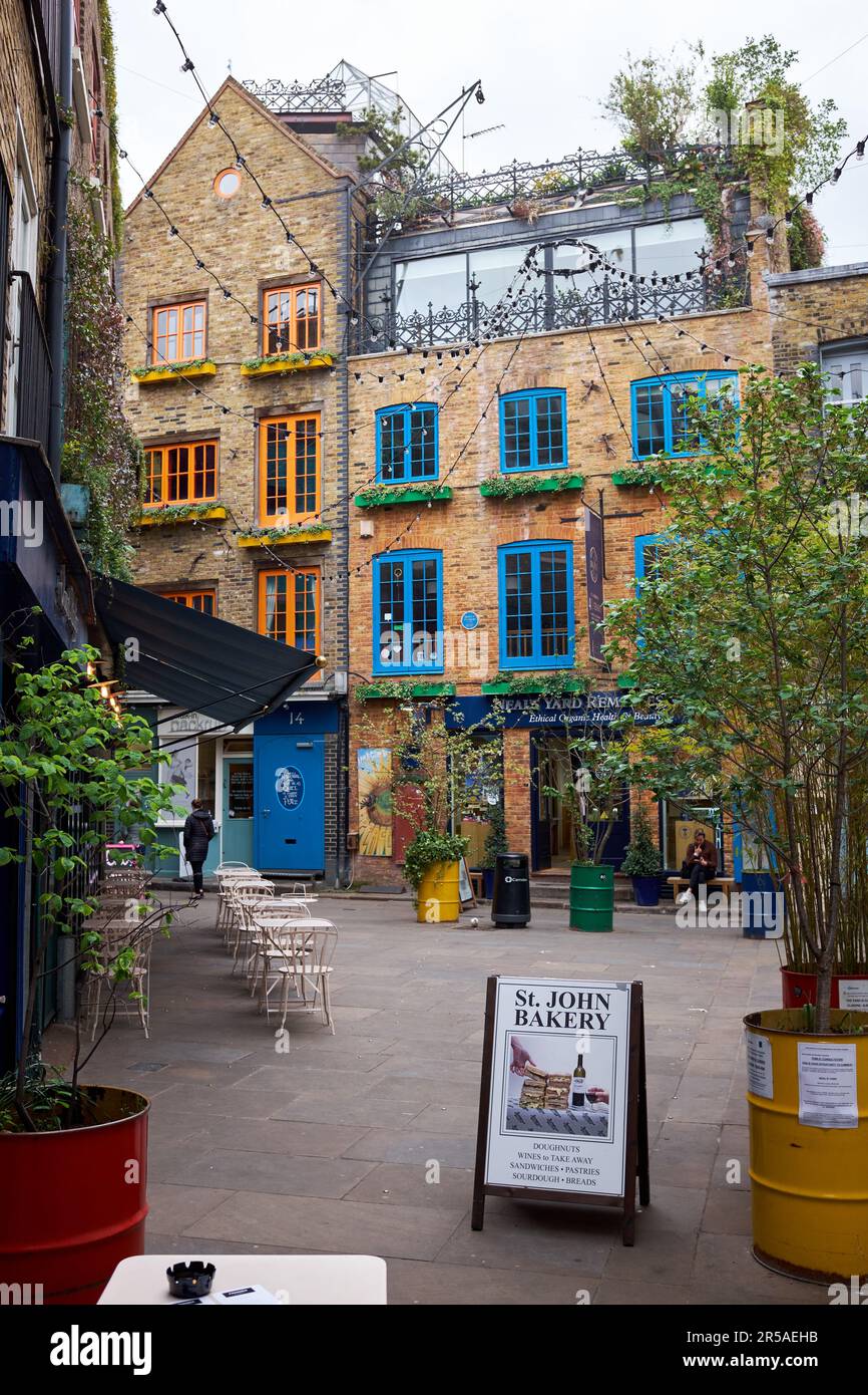 London, UK - April 27, 2022: Neals Yard with no people. A small alley in Covent Garden with colourful victorian houses used for health food cafes and Stock Photo
