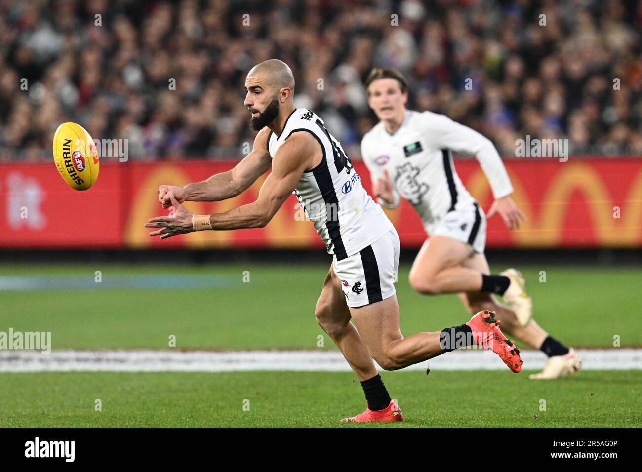 Melbourne, Australia. 02nd June, 2023. Alex Cincotta of Carlton tackles  Kysaiah Pickett of Melbourne during the AFL Round 12 match between the  Melbourne Demons and the Carlton Blues at the Melbourne Cricket