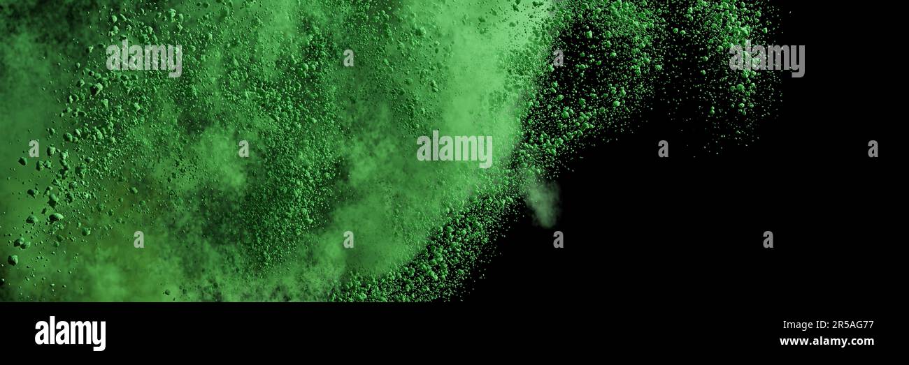 green particles flying, colored powder in the air, isolated on black background Stock Photo