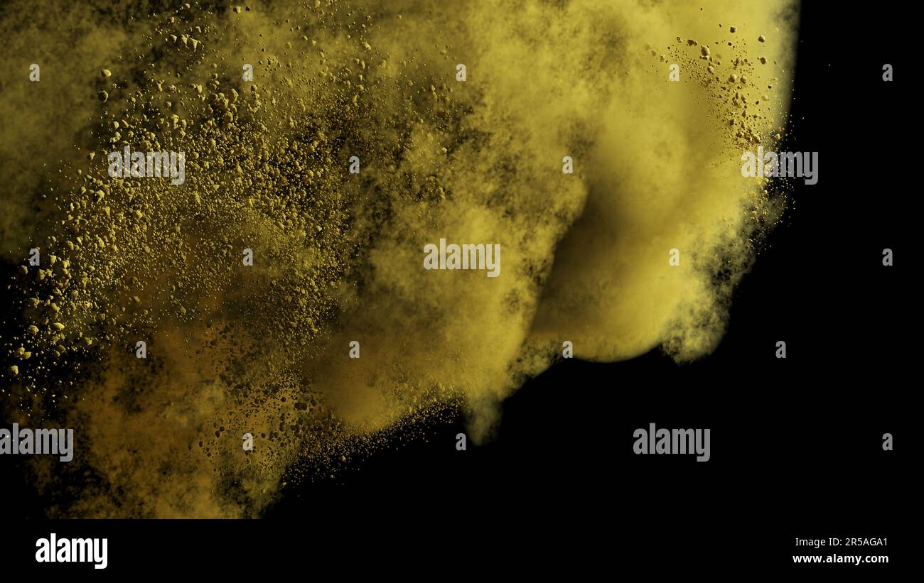 yellow coloured powder tossed in the air, isolated on black background Stock Photo