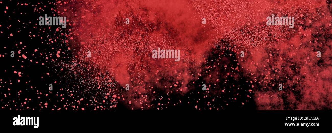 red particles flying, colored powder isolated on black background banner Stock Photo