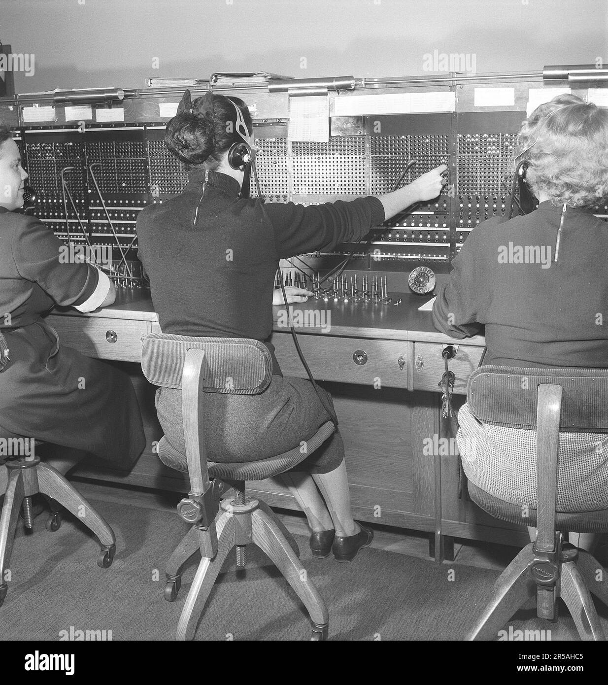 Telephony in the 1950s. Women working at a telephone switchboard as it