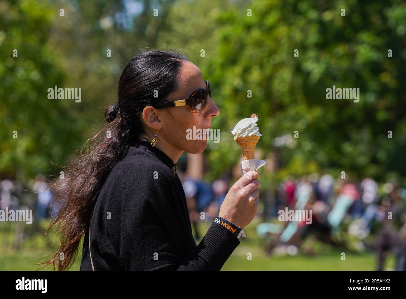 London UK. 2 June 2023 .A woman enjoys an icecream on a sunny day in Saint James Park London. The Met Office forecast warmer temperatures as the country enters the official summer season.Credit: amer ghazzal/Alamy Live News Stock Photo