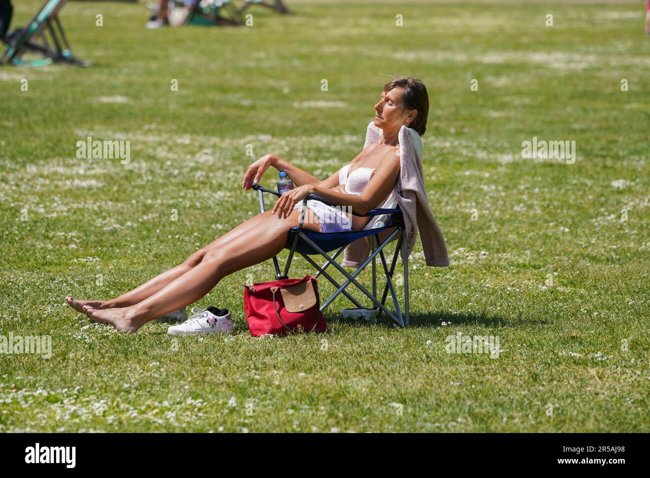 London UK. 2 June 2023 . A woman sunbathing on a sunny day in Saint James Park London. The Met Office forecast warmer temperatures as the country enters the official summer season.Credit: amer ghazzal/Alamy Live News Stock Photo