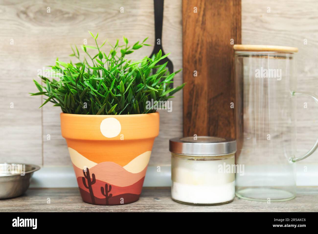 Artificial plant in a clay terracotta pot. Hand painted with acrylics