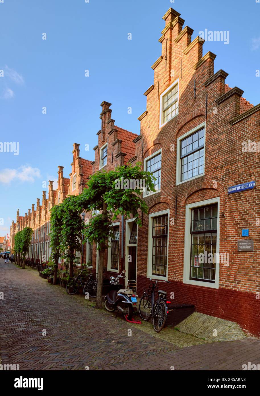 Haarlem, Netherlands - MAY 24, 2022: Row of houses with stepped gables in Groot Heiligland street in old town. Diminishing perpsective. Stock Photo