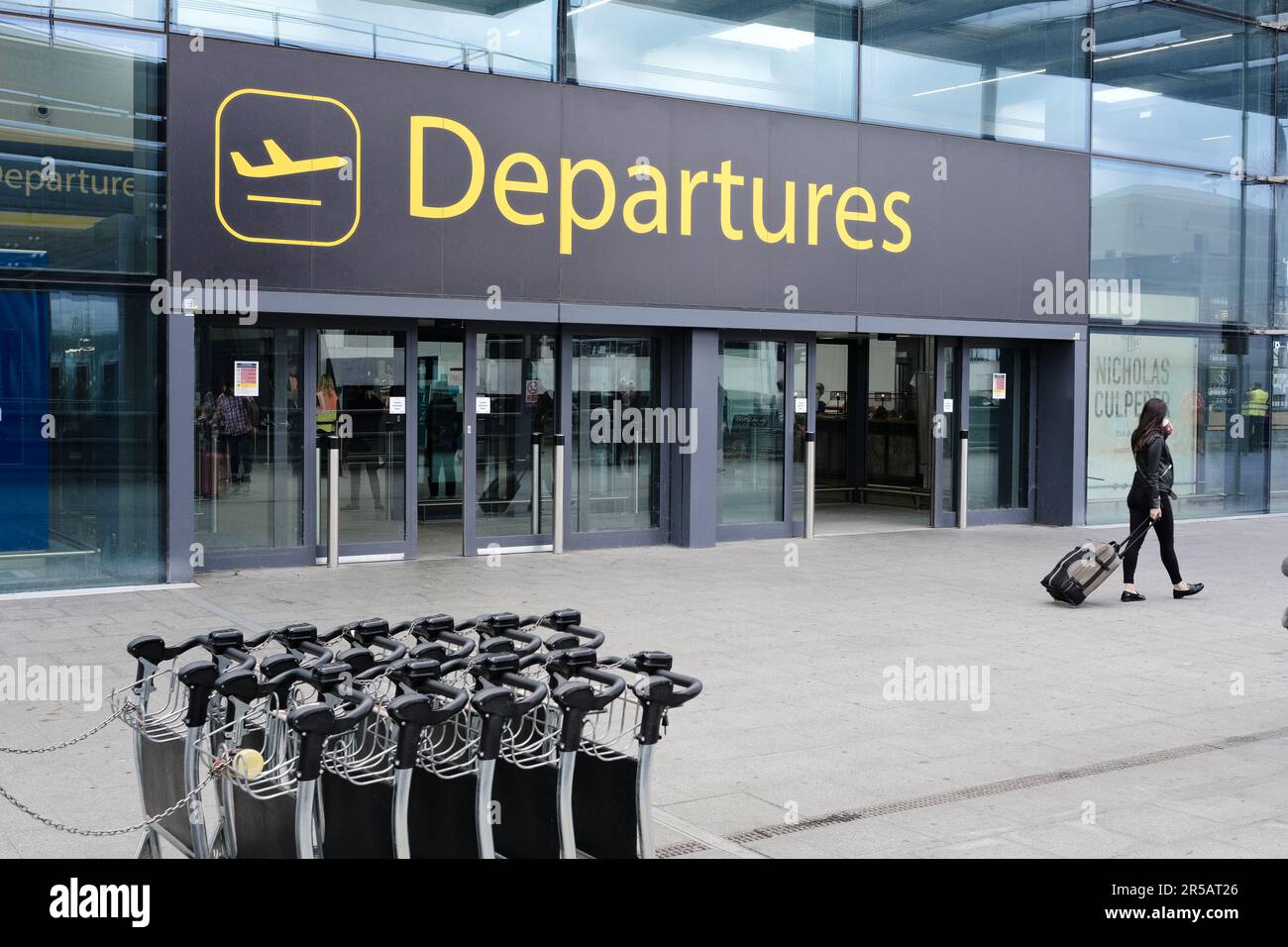 Woman pulling luggage trolley hires stock photography and images Alamy