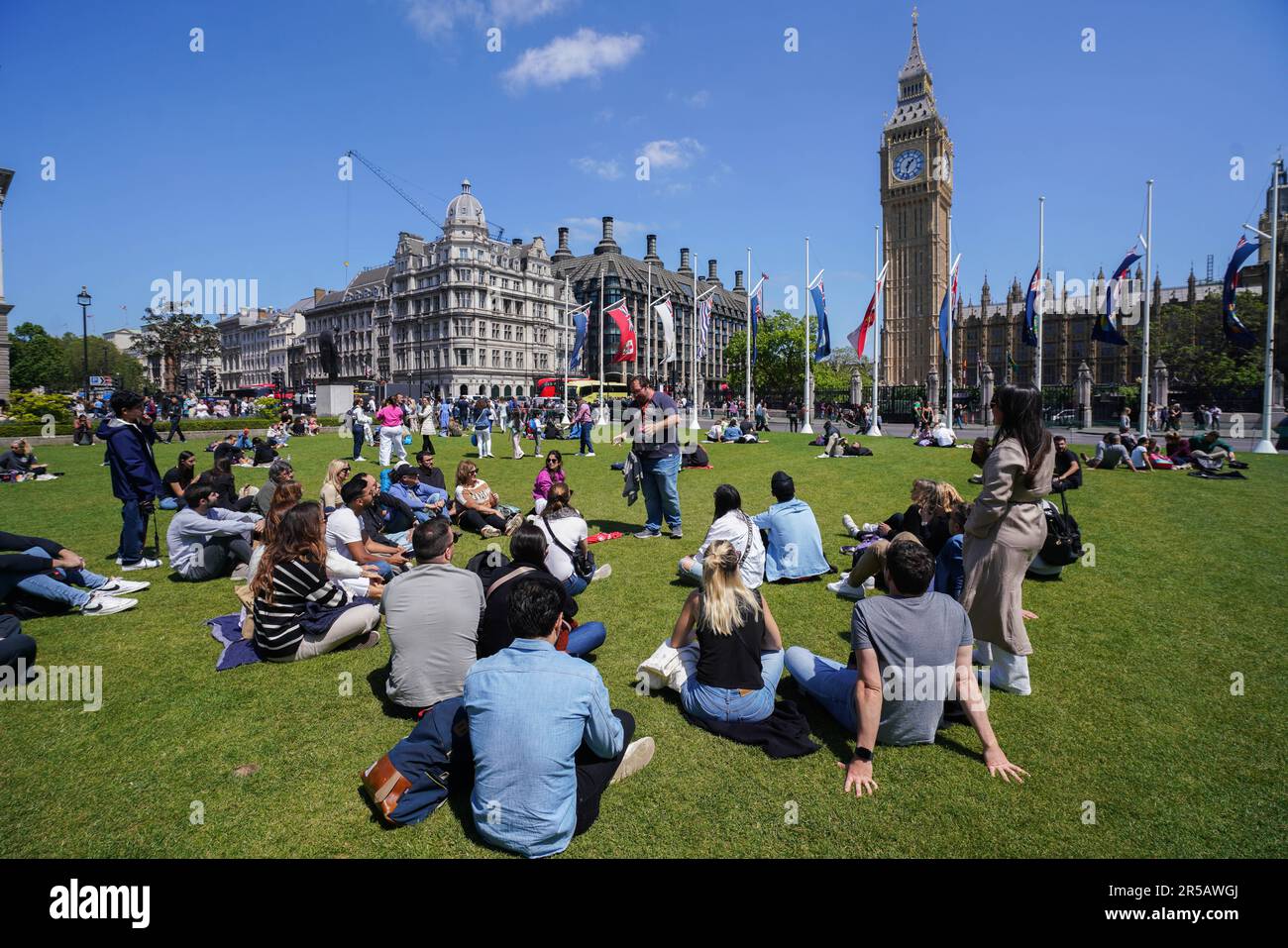 London UK. 2 June 2023 . People enjoying the warm sunshine in Parliament Square London. The Met Office forecast warmer temperatures as the country enters the official summer season.Credit: amer ghazzal/Alamy Live News Stock Photo