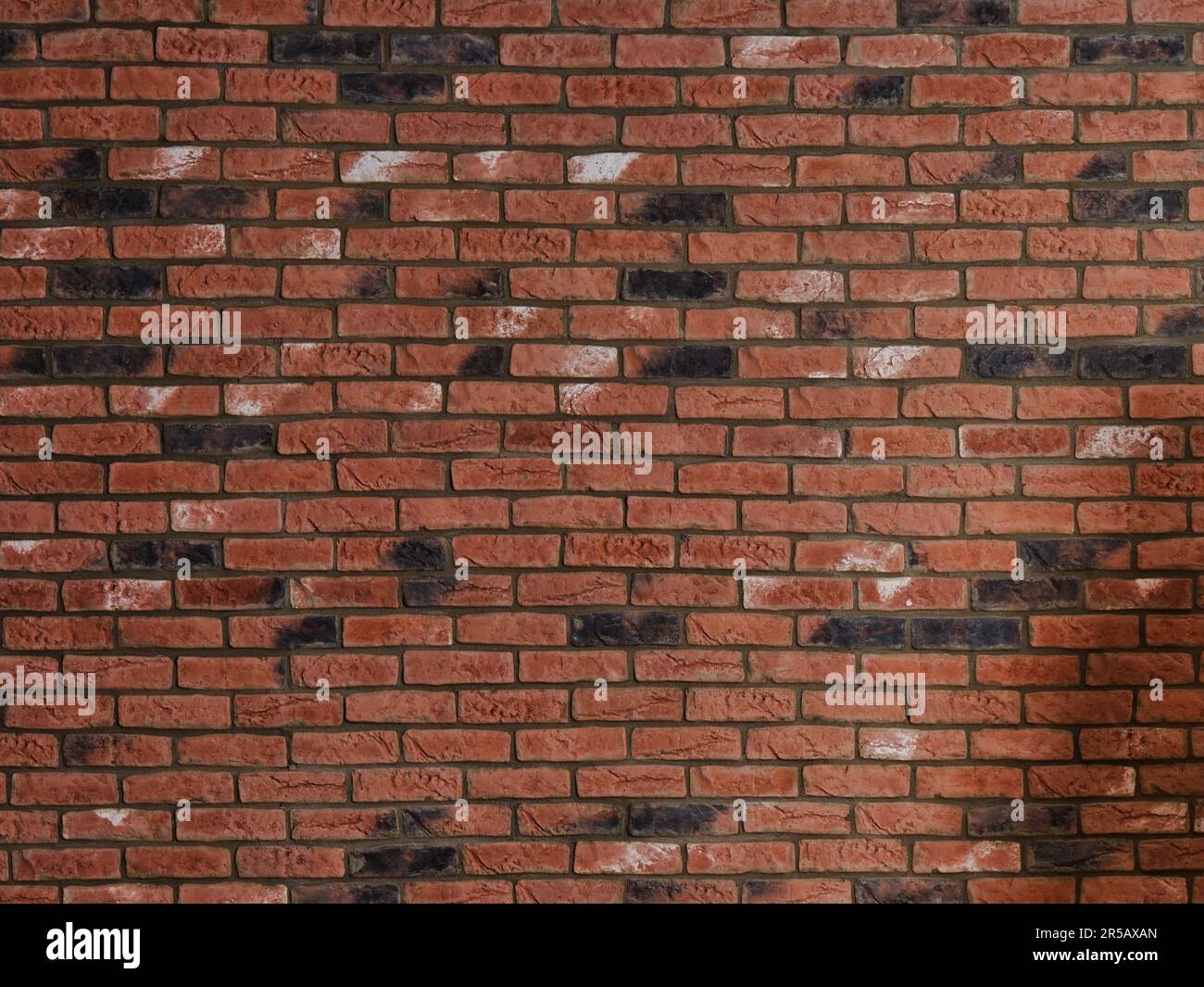 Red brick wall texture with dark weathered bricks and horizontal masonry pattern, suitable as an architectural background, urban surface or constructi Stock Photo