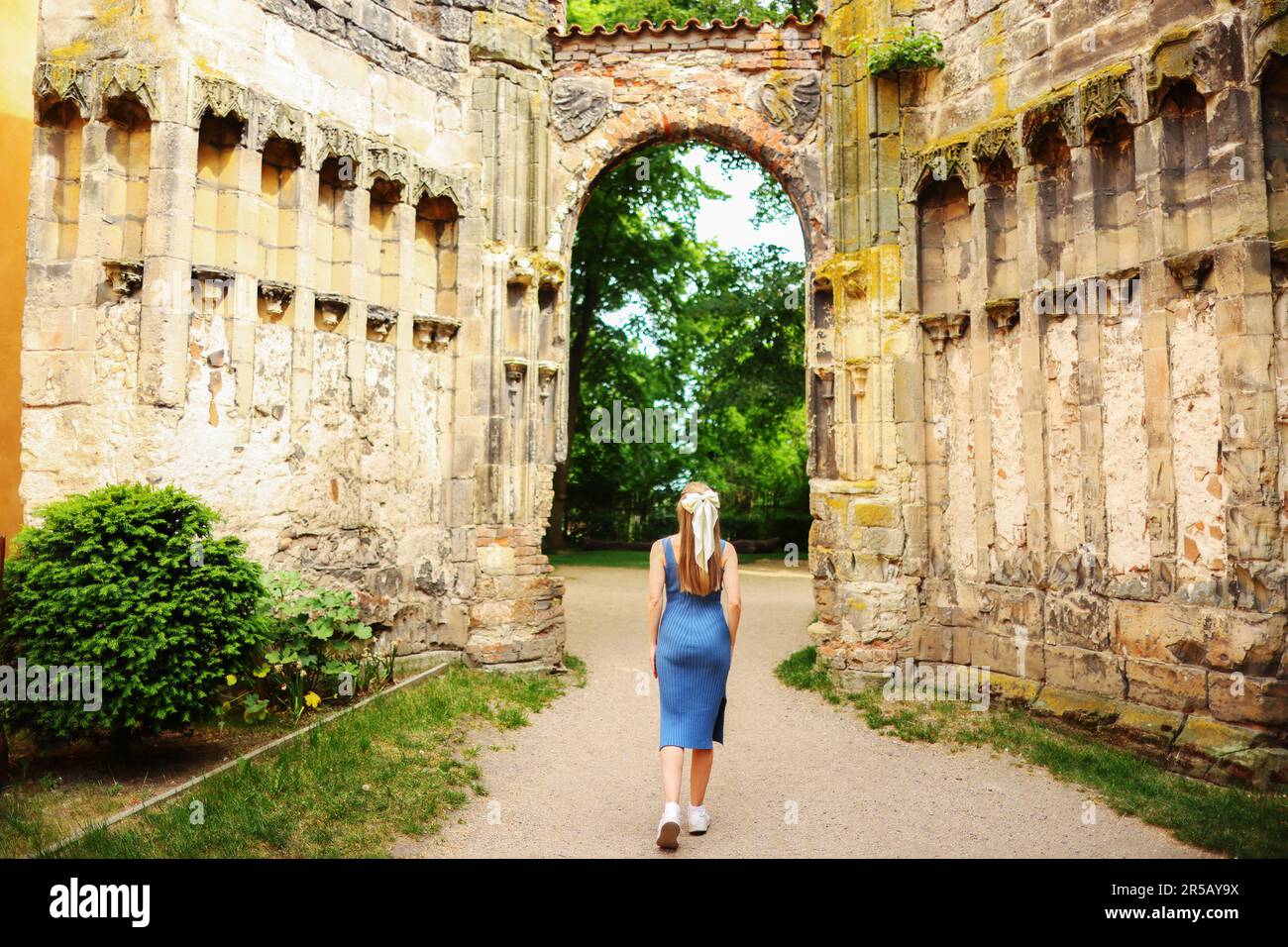 girl stay back and going to the ruins of an old church  Stock Photo