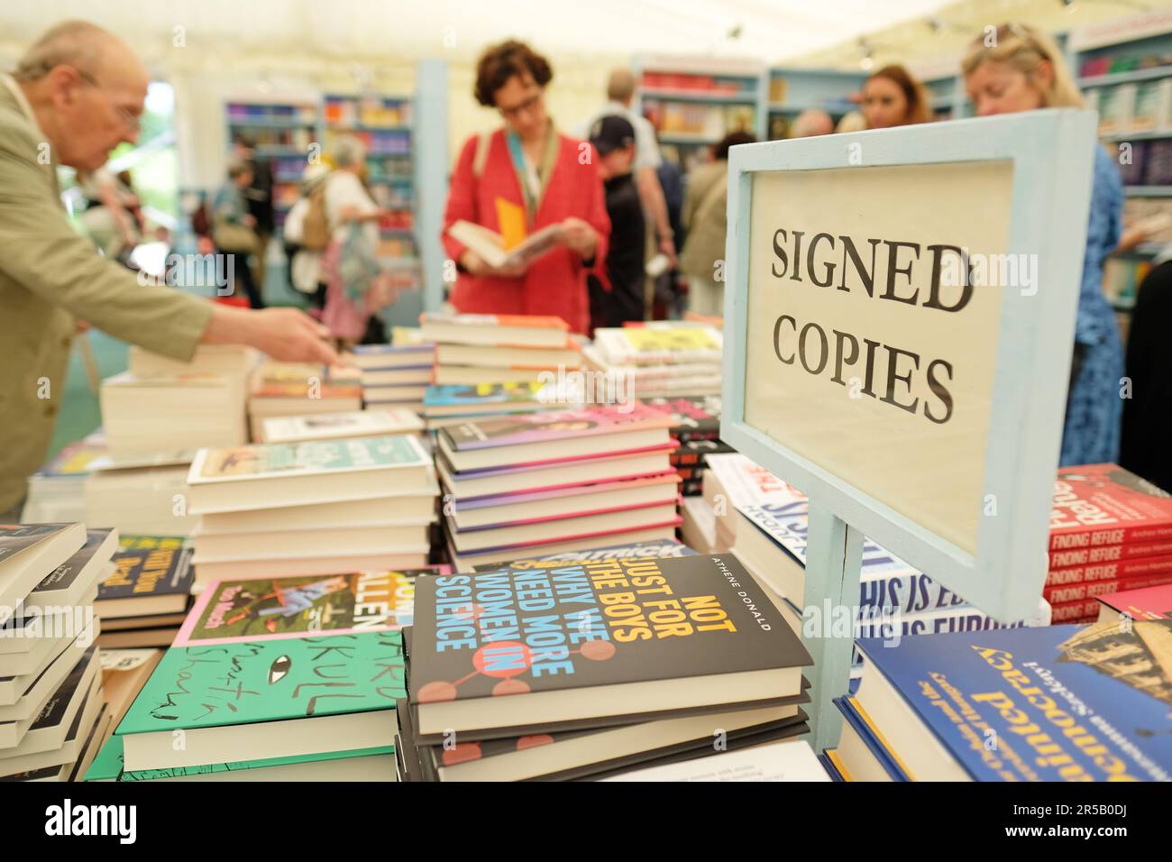 Hay Festival, Hay on Wye, Wales, UK – Friday 2nd June 2023 – Visitors browse the signed books in the Festival bookshop during the ninth day of this years Hay Festival. Photo Steven May / Alamy Live News Stock Photo