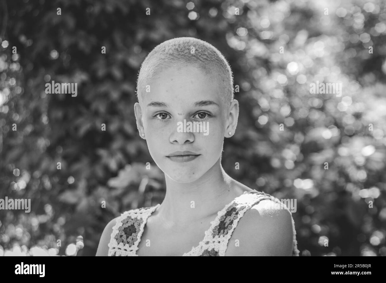Portrait of a girl with very short hair. Black and white portrait. Stock Photo