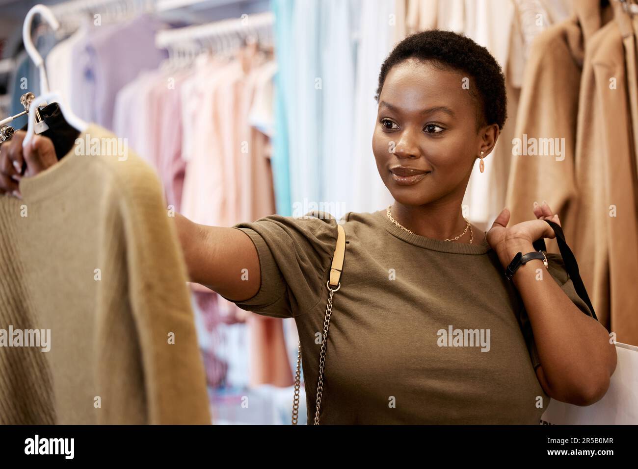 Fashion, shopping and smile with black woman in boutique store for luxury, sale and retail. Choice, product and consumerism with female customer Stock Photo