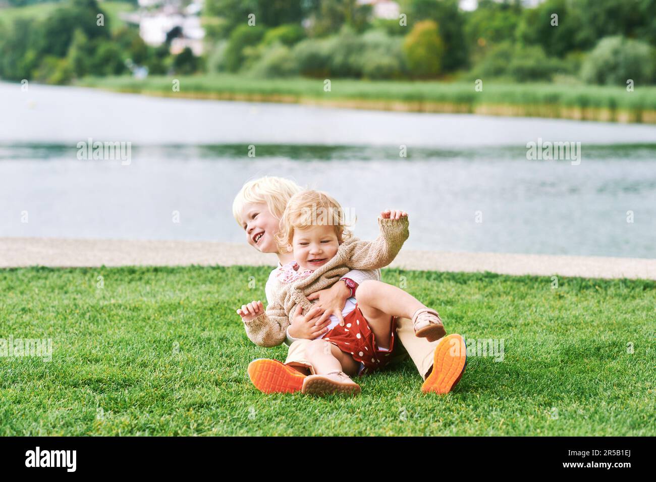 Outdoor portrait of adorable happy children playing together next to