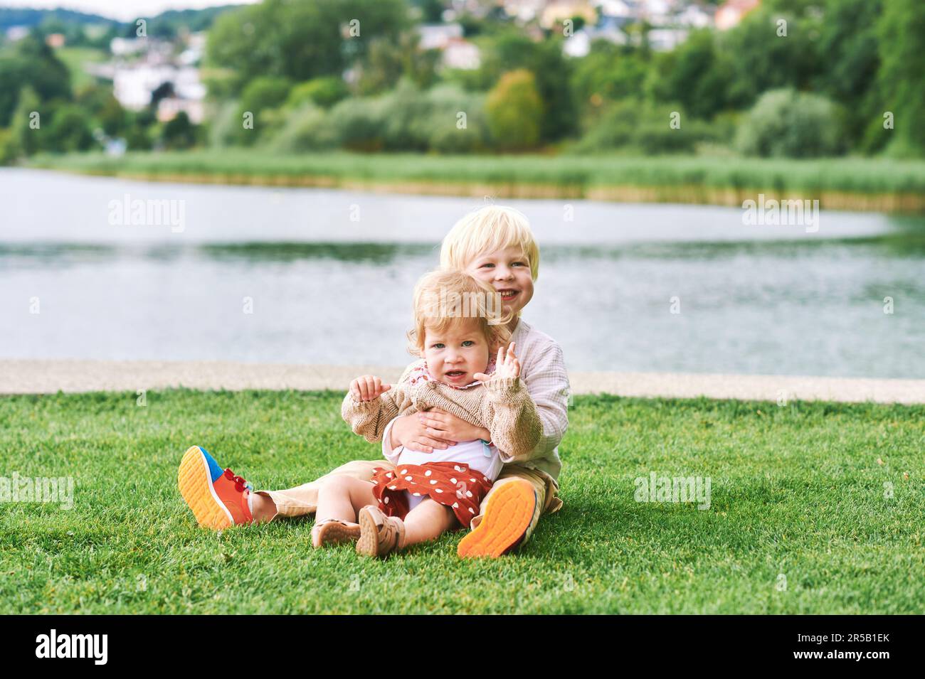Outdoor portrait of adorable happy children playing together next to