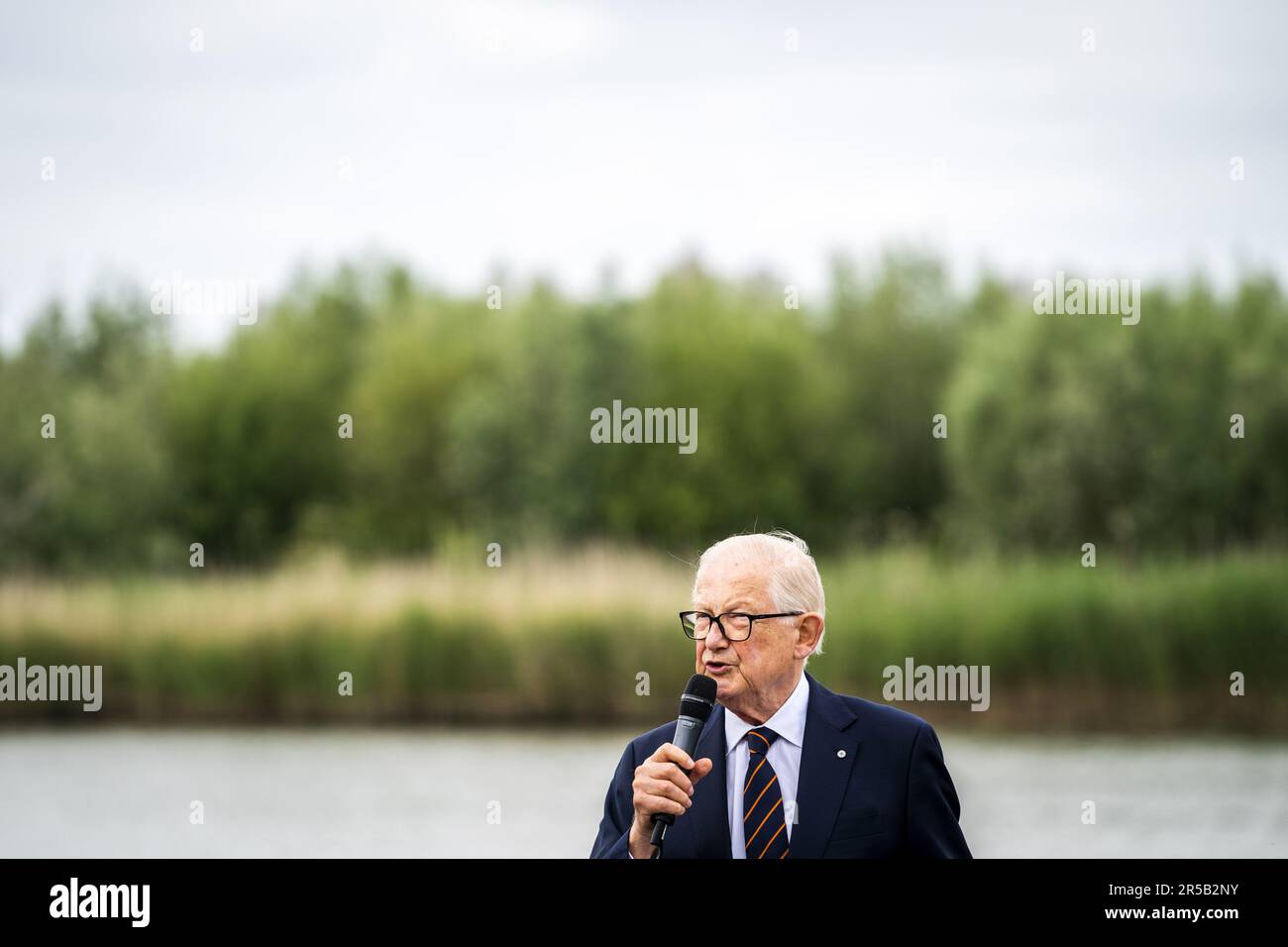 WORKENDAM - Prof. dr. mr. Pieter van Vollenhoven during the release of sturgeons in the water of De Biesbosch National Park. The release and tracking of the tagged animals is an important step in exploring the possibility of reintroduction of this fish species. ANP JEROEN JUMELET netherlands out - belgium out Stock Photo